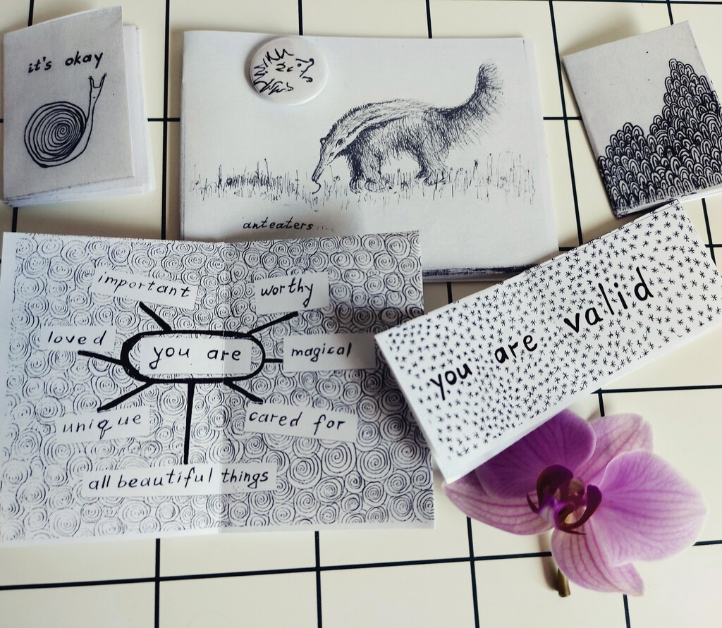 multiple zines laid out on the white surface